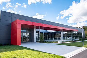 Exterior elevation with striking red and silver exterior cladding for Starlim - London, ON